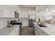 Well-lit kitchen with stainless steel appliances, white cabinets, and a spacious island with sink at 9738 E Tiburon Ave, Mesa, AZ 85212