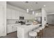 Stylish kitchen with white cabinets, stainless steel appliances, and a center island with comfortable seating at 9738 E Tiburon Ave, Mesa, AZ 85212