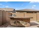 Outdoor kitchen area with a built-in grill and counter space, set against a brick privacy wall at 9738 E Tiburon Ave, Mesa, AZ 85212