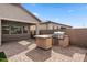 Outdoor kitchen with stainless steel grill, nestled under a covered patio with brick flooring at 9738 E Tiburon Ave, Mesa, AZ 85212