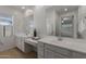 Bright bathroom featuring double vanity sinks with large mirrors and ample counter space at 9838 E Research Ave, Mesa, AZ 85212