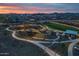 Aerial view of the playground and walking path in the community park at dusk at 9838 E Research Ave, Mesa, AZ 85212