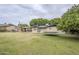 Expansive backyard with lush grass, a trampoline, and a gazebo, creating an ideal space for Gathering fun at 1035 W 2Nd St, Mesa, AZ 85201