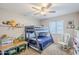 Cozy bedroom with bunk beds, ceiling fan, and natural light from window at 1035 W 2Nd St, Mesa, AZ 85201