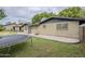 Exterior view of house with brick siding, black trim, yard, and covered patio at 1035 W 2Nd St, Mesa, AZ 85201