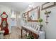 Hallway featuring wood floors, console table with decor, and framed artwork enhancing the interior ambiance at 1035 W 2Nd St, Mesa, AZ 85201