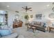 Comfortable living room featuring stylish decor, ceiling fan and a shiplap accent wall at 1035 W 2Nd St, Mesa, AZ 85201