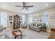 Spacious living room with natural lighting, comfortable seating, stylish décor, and modern ceiling fan at 1035 W 2Nd St, Mesa, AZ 85201