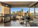 Relax on the balcony with grill, seating, and a picturesque view of swaying palms and clear blue sky at 1040 E Osborn Rd # 203, Phoenix, AZ 85014