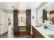 Bathroom featuring sleek countertops with a vanity area, mirrored cabinets, and stylish fixtures, maximizing style and function at 1040 E Osborn Rd # 203, Phoenix, AZ 85014