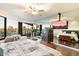 Bright bedroom featuring expansive windows, a ceiling fan, and a sleek mirrored wall, enhancing the sense of space at 1040 E Osborn Rd # 203, Phoenix, AZ 85014