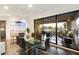 Light-filled dining area with glass table, chairs, and a sliding door to the outdoor balcony at 1040 E Osborn Rd # 203, Phoenix, AZ 85014