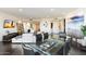 Open-plan dining room with modern glass table and chairs, flowing into the living area at 1040 E Osborn Rd # 203, Phoenix, AZ 85014