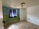 This bedroom shows two-tone walls and a window with a dark curtain at 10951 N 91St Ave # 206, Peoria, AZ 85345