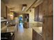 An eat-in kitchen shows wood cabinets and white appliances against a light tile floor at 10951 N 91St Ave # 206, Peoria, AZ 85345