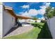 A large backyard with green grass, a stone border and covered patio that abuts a swimming pool at 11221 N 32Nd St, Phoenix, AZ 85028