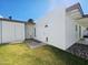 Exterior view of home and backyard with green grass and rock at 11221 N 32Nd St, Phoenix, AZ 85028
