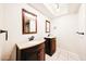 Double sink bathroom with sleek dark cabinets, granite counters, and decorative mirrors at 11221 N 32Nd St, Phoenix, AZ 85028