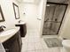 Bathroom featuring dual sinks with dark cabinetry and a glass enclosed shower at 11221 N 32Nd St, Phoenix, AZ 85028