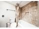 Nicely tiled bathroom featuring a toilet and a bath tub with shower, exuding a modern and clean vibe at 11221 N 32Nd St, Phoenix, AZ 85028