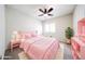 Charming bedroom with a pink bed, matching furniture, and ample natural light at 11221 N 32Nd St, Phoenix, AZ 85028