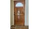Stylish wooden front door with decorative glass panel, adding a touch of elegance to the entrance at 11221 N 32Nd St, Phoenix, AZ 85028