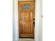 Elegant wooden front door with decorative glass pane enhancing the home's entryway at 11221 N 32Nd St, Phoenix, AZ 85028