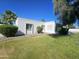 Well-maintained front yard with lush green grass, mature trees, and attractive landscaping features at 11221 N 32Nd St, Phoenix, AZ 85028