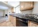 Bright kitchen features sleek black counters and mosaic tile backsplash at 11221 N 32Nd St, Phoenix, AZ 85028