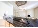 Open-concept kitchen and living area with stylish dark countertops at 11221 N 32Nd St, Phoenix, AZ 85028