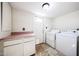 Functional laundry room features storage cabinets, countertop space, and appliances, blending convenience and practicality at 11221 N 32Nd St, Phoenix, AZ 85028