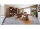 Bright home office featuring a built-in bookcase, a large window, and a wood desk at 11221 N 32Nd St, Phoenix, AZ 85028