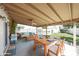 Inviting covered patio with dining and seating areas, overlooking the green backyard and pool at 11221 N 32Nd St, Phoenix, AZ 85028