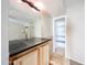 Cozy wet bar with dark countertop and storage cabinets at 11221 N 32Nd St, Phoenix, AZ 85028