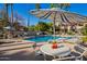 Relaxing pool area with ample seating, shade, and a sparkling blue pool, perfect for enjoying sunny days at 11515 N 91St St # 142, Scottsdale, AZ 85260