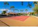 Well-maintained community tennis court surrounded by lush landscaping and palm trees, ideal for active residents at 11515 N 91St St # 142, Scottsdale, AZ 85260