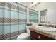 Bathroom with patterned shower curtain, modern vanity and granite counters at 11779 E Becker Ln, Scottsdale, AZ 85259