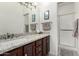 Bathroom vanity with decorative mirror and hardware with separate shower at 11779 E Becker Ln, Scottsdale, AZ 85259