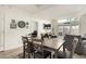 Bright dining area with wooden table set, rug, and a view to the outdoor living space at 11779 E Becker Ln, Scottsdale, AZ 85259