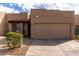 Charming single-story home with a two-car garage, desert landscaping, and a red tiled entry roof at 11779 E Becker Ln, Scottsdale, AZ 85259