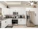 Modern kitchen featuring stainless steel appliances, granite countertops, and white cabinetry at 11779 E Becker Ln, Scottsdale, AZ 85259