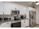 Contemporary kitchen featuring stainless steel appliances, granite countertops, and ample storage space at 11779 E Becker Ln, Scottsdale, AZ 85259