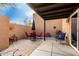 Inviting covered patio area with pavers, comfortable seating, and space for outdoor dining at 11779 E Becker Ln, Scottsdale, AZ 85259