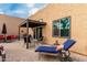 Relaxing outdoor space with a lounge chair, dining area, and sliding glass door for indoor-outdoor living at 11779 E Becker Ln, Scottsdale, AZ 85259