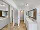 Well-lit bathroom featuring double vanity sinks, large mirrors, and tiled floors at 12037 S Bannock St, Phoenix, AZ 85044