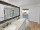 Elegant bathroom with a double sink vanity and large mirror with a decorative frame at 12037 S Bannock St, Phoenix, AZ 85044