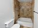 Cozy bathroom with a tiled shower-tub combination and a toilet with white ceramic at 12037 S Bannock St, Phoenix, AZ 85044