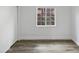 Neutral bedroom featuring laminate floors, a window, and a large closet at 12037 S Bannock St, Phoenix, AZ 85044