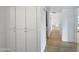 Hallway with built-in storage cabinets with contemporary wood-look flooring at 12037 S Bannock St, Phoenix, AZ 85044