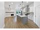 Spacious kitchen features a large island, modern appliances, and an adjacent dining area with a fireplace at 12037 S Bannock St, Phoenix, AZ 85044